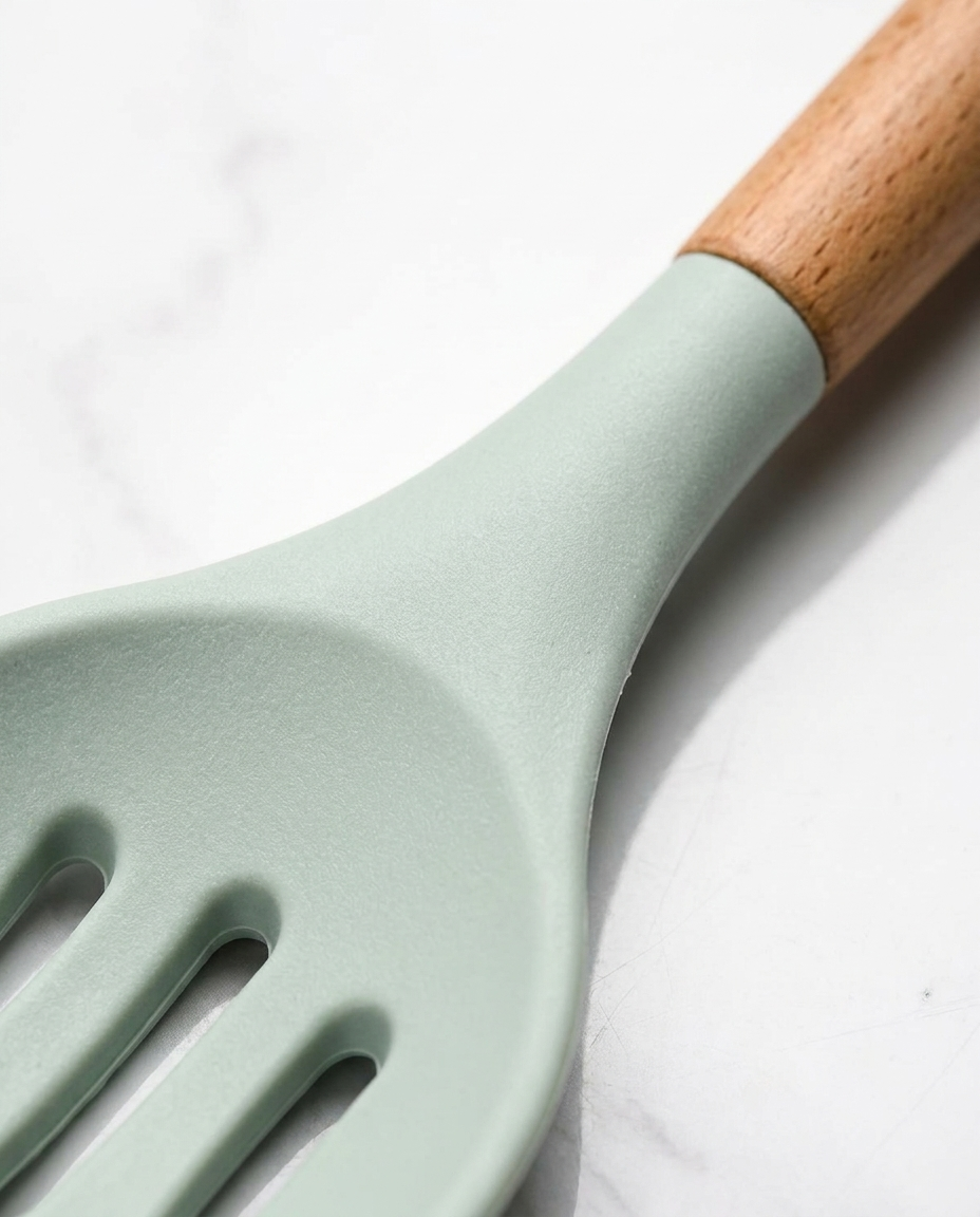 Close-up of wooden handle grain and heat-resistant silicone head texture