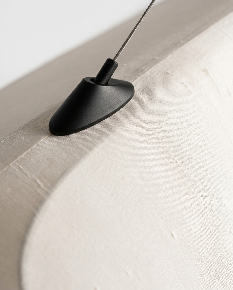 Close-up detail of the silk shade texture and pendant fixture finish