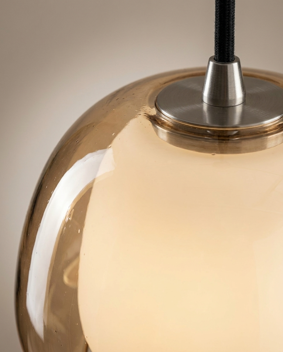 Close-up detail of the glass dome shade and adjustable pendant fixture finish